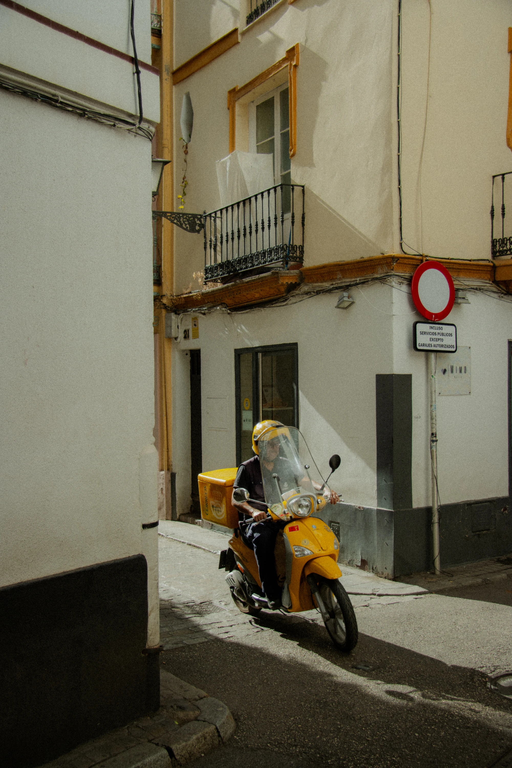 Correos scooter parked on a street, side view