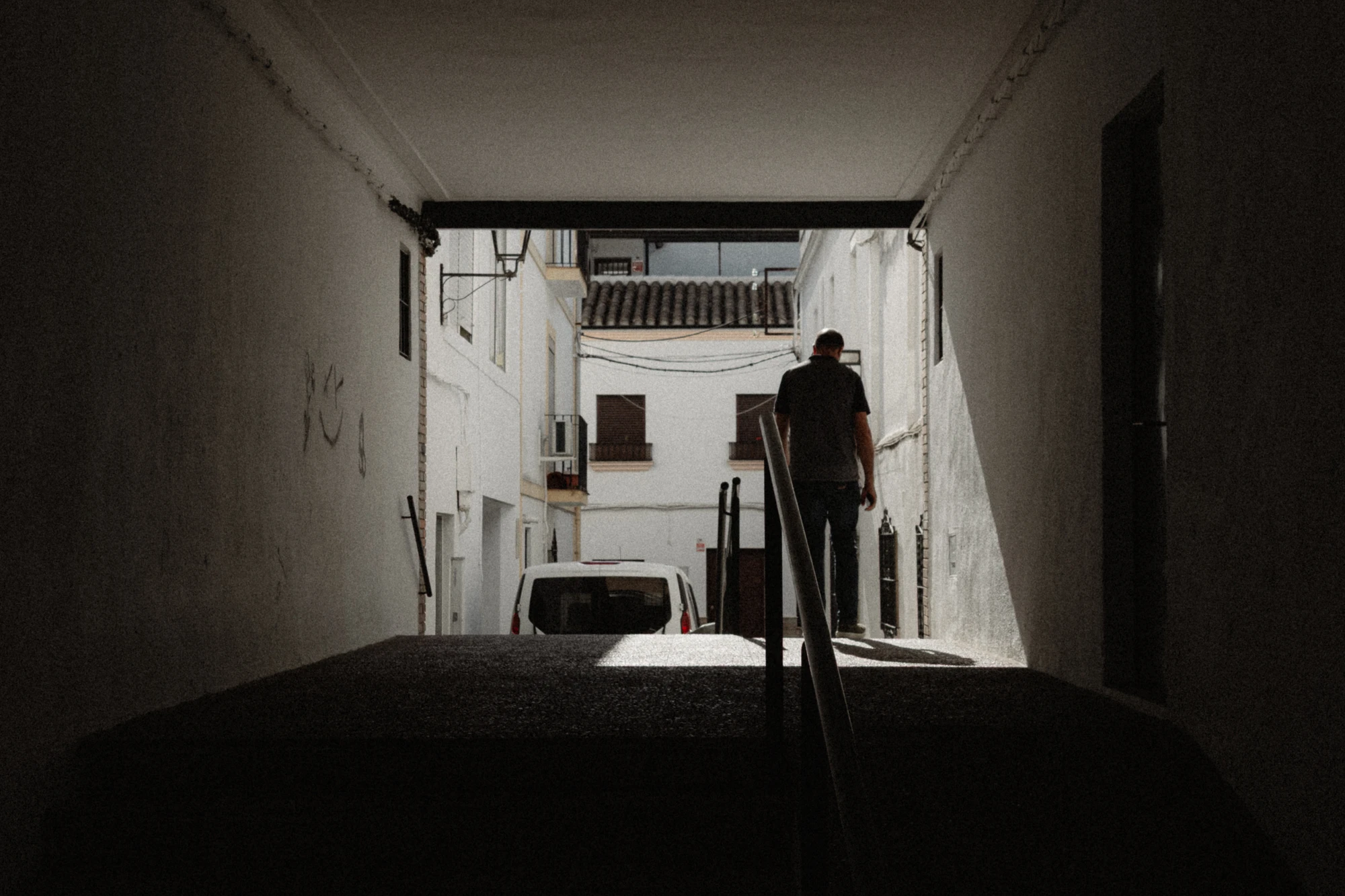 Silhouette of a person in a dark passageway
